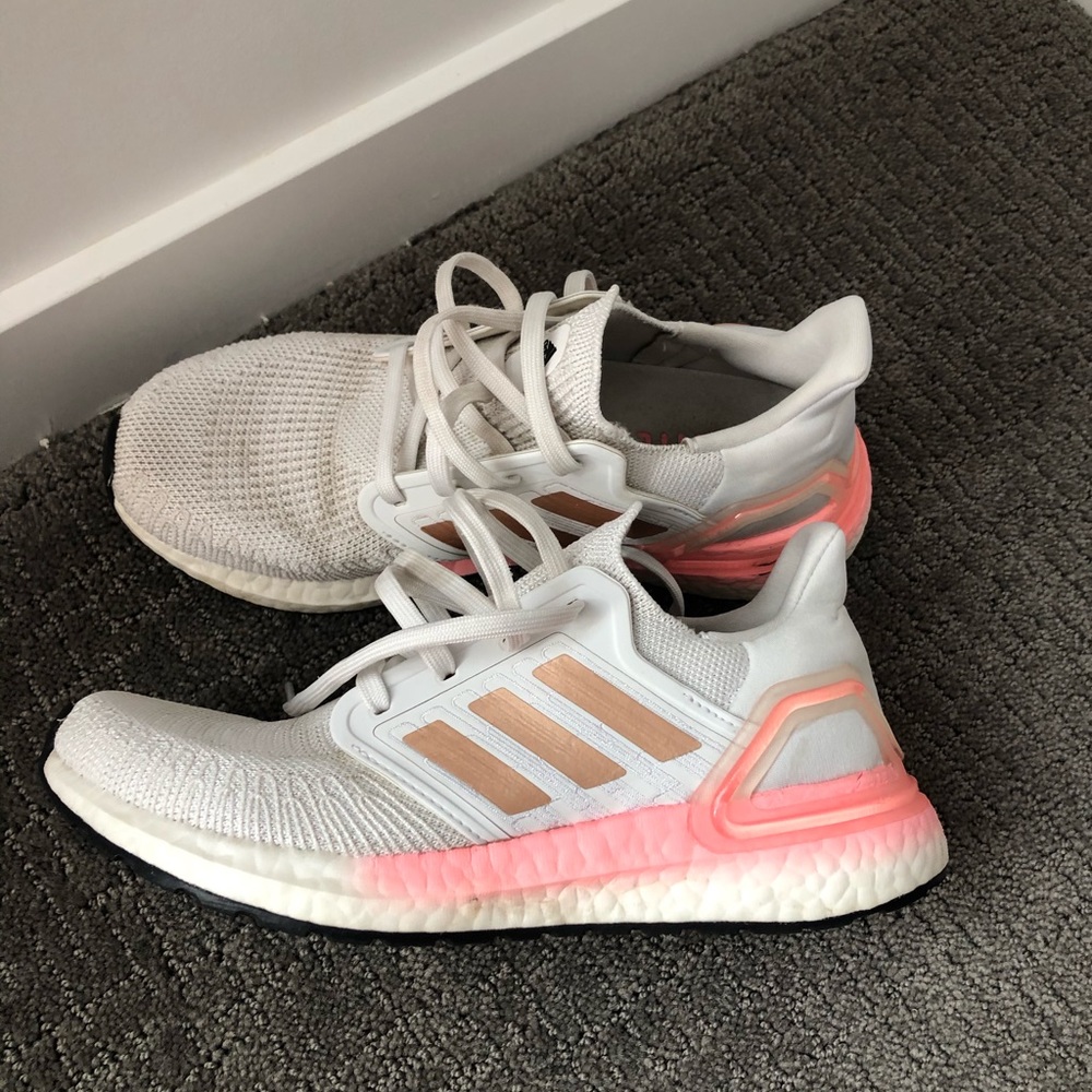Pink and white adidas ultra boost shoes